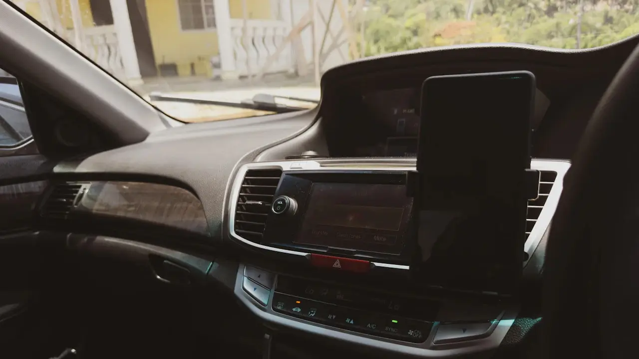 A phone mounted on a car’s dashboard beside the centre screen.