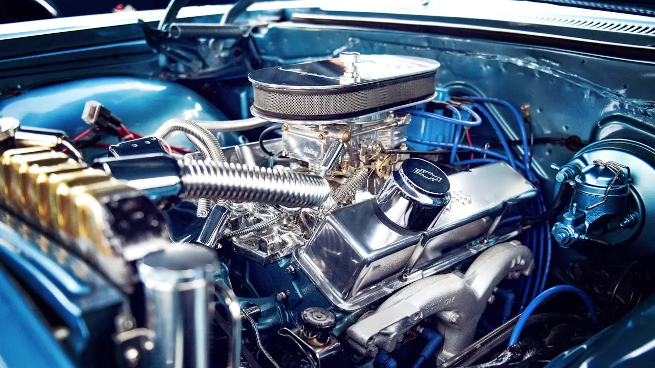 A polished V8 engine with its air cleaner, oil filler cap and spark-plug wires.
