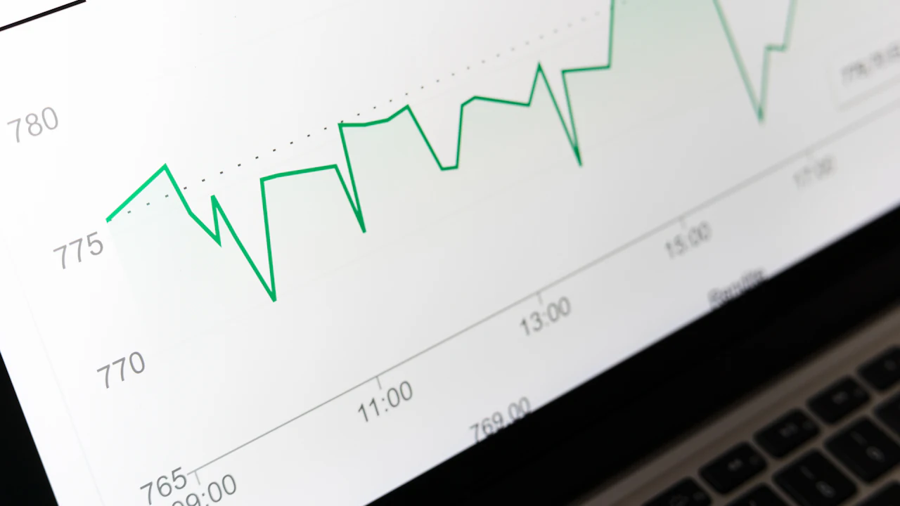A line chart displayed on a laptop screen showing a rising and falling trace