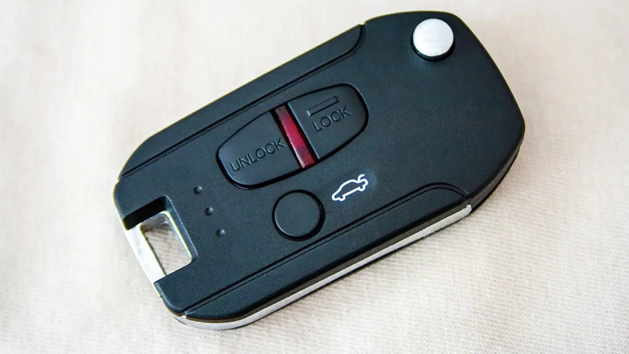 A black flip-key fob with lock, unlock and trunk buttons.