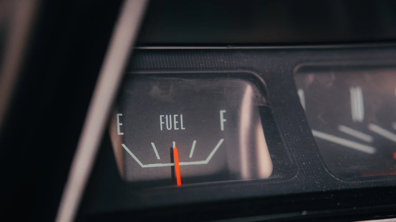 A car fuel gauge photographed close up with the needle at empty