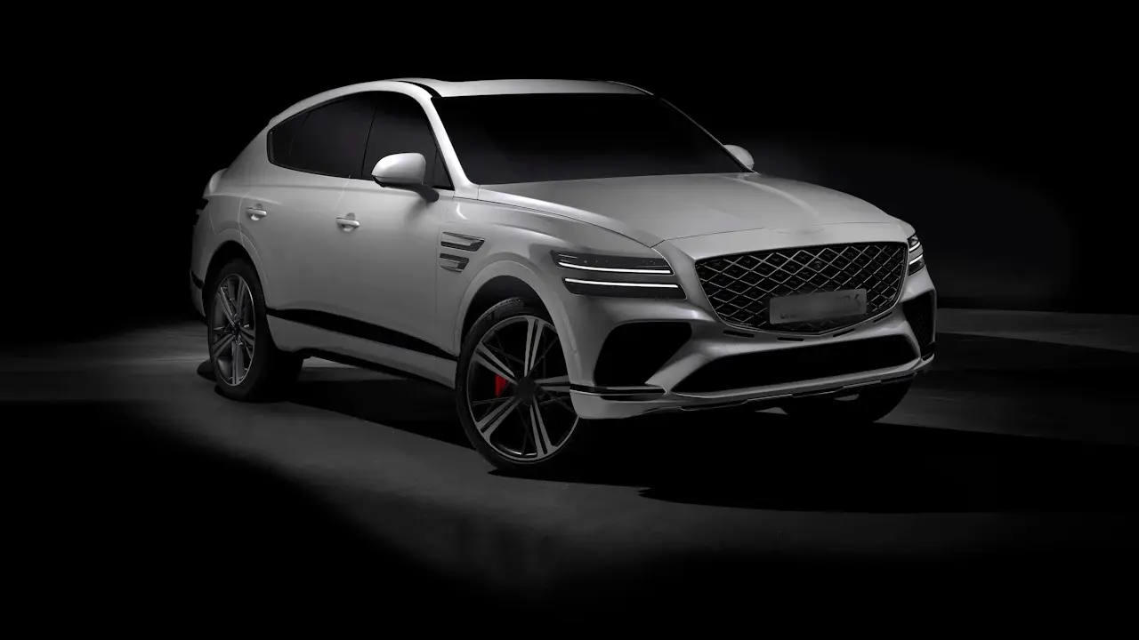 A white Genesis GV80 SUV photographed in a dark studio.