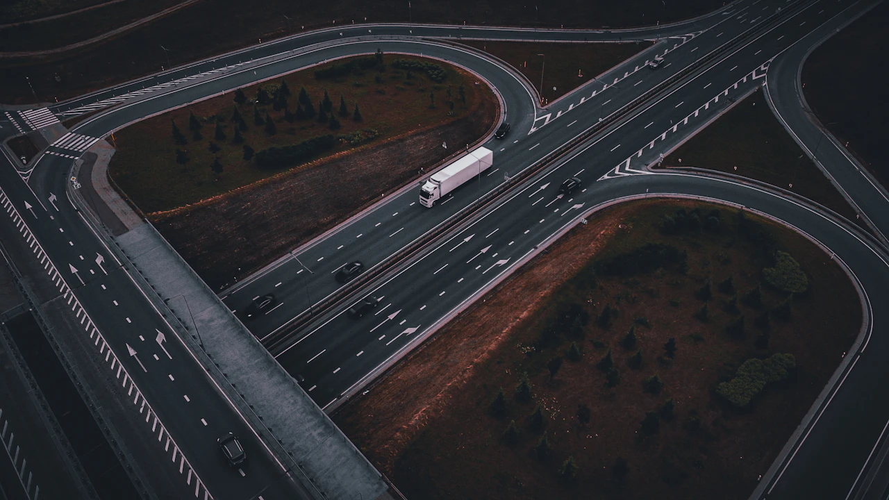 An aerial view of a motorway interchange with a lorry crossing the flyover
