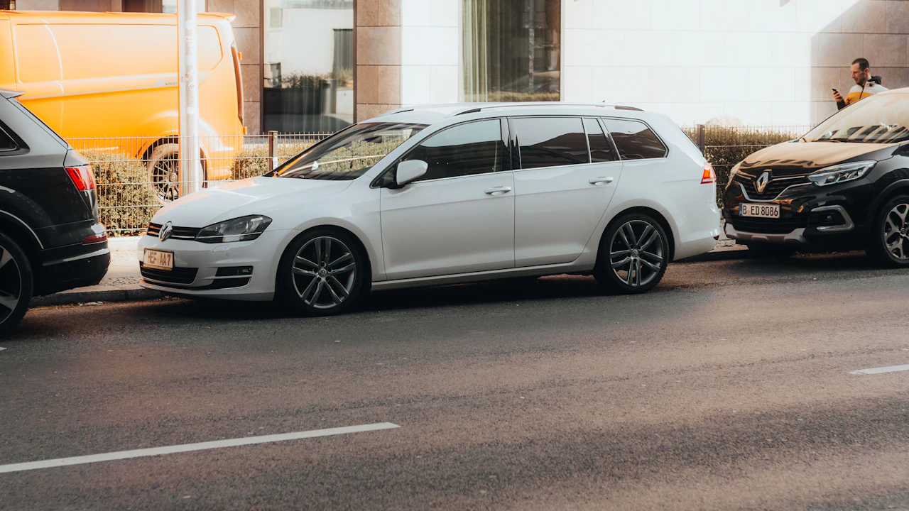 White station wagon parked on a city street