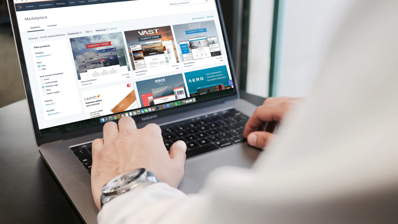 A person browsing car listings on a laptop at a desk