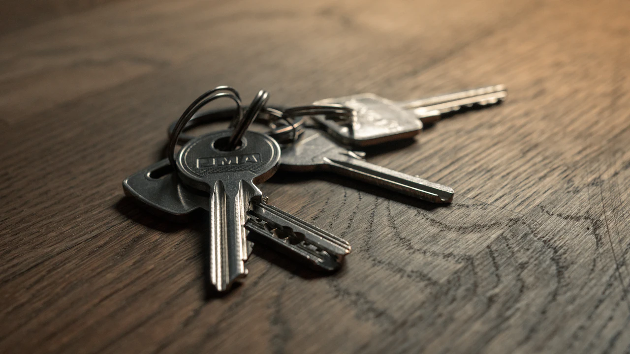 A set of car keys lying on a wooden table