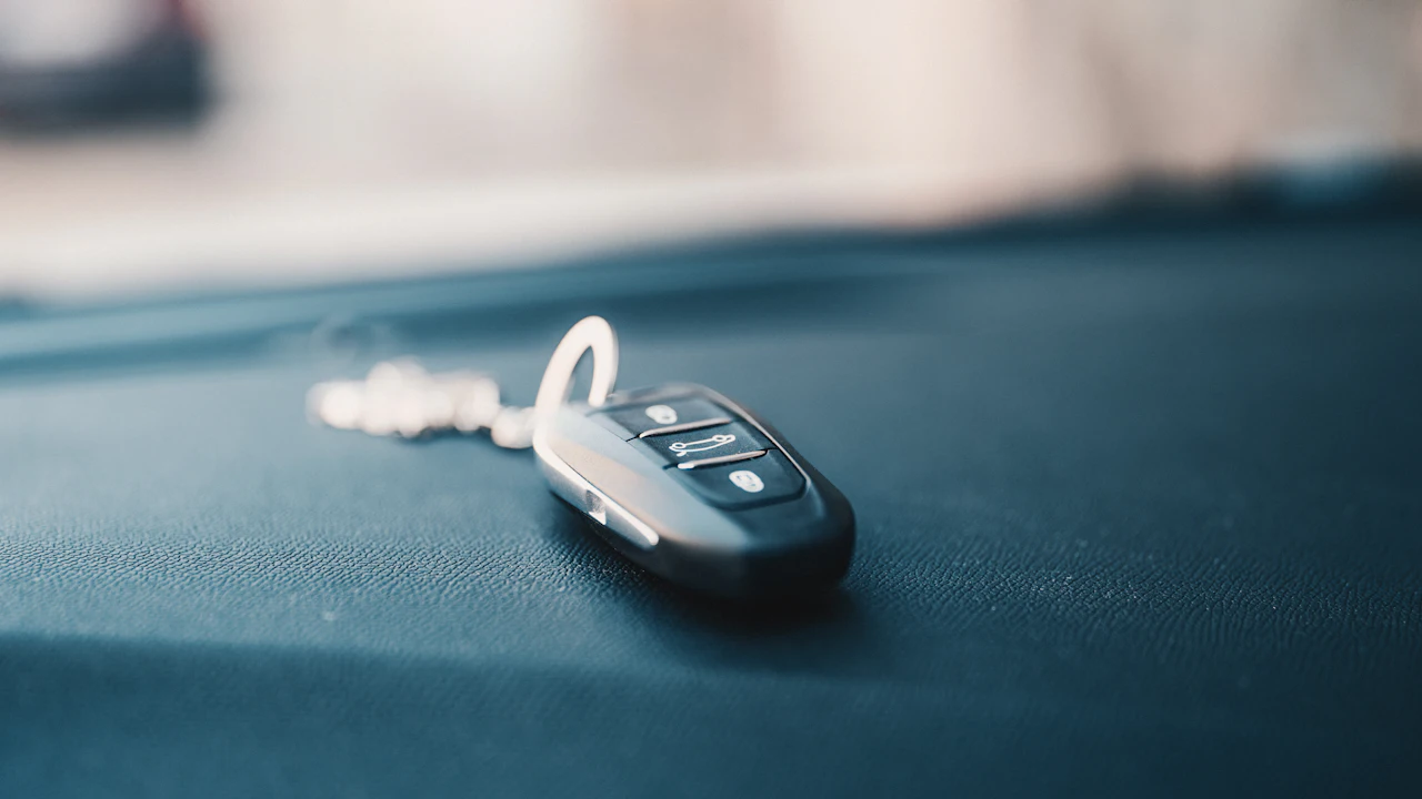A car key resting on a seat after a sale has completed