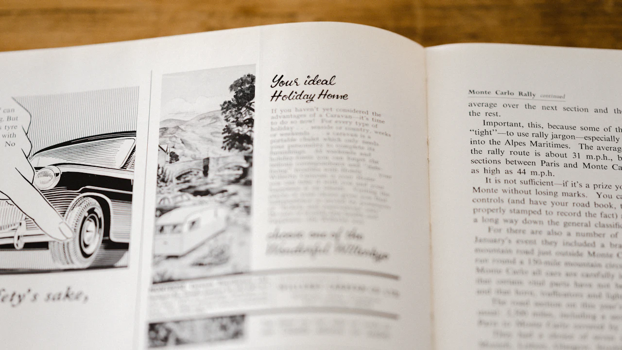 An open period motoring publication showing black and white car advertisements and text