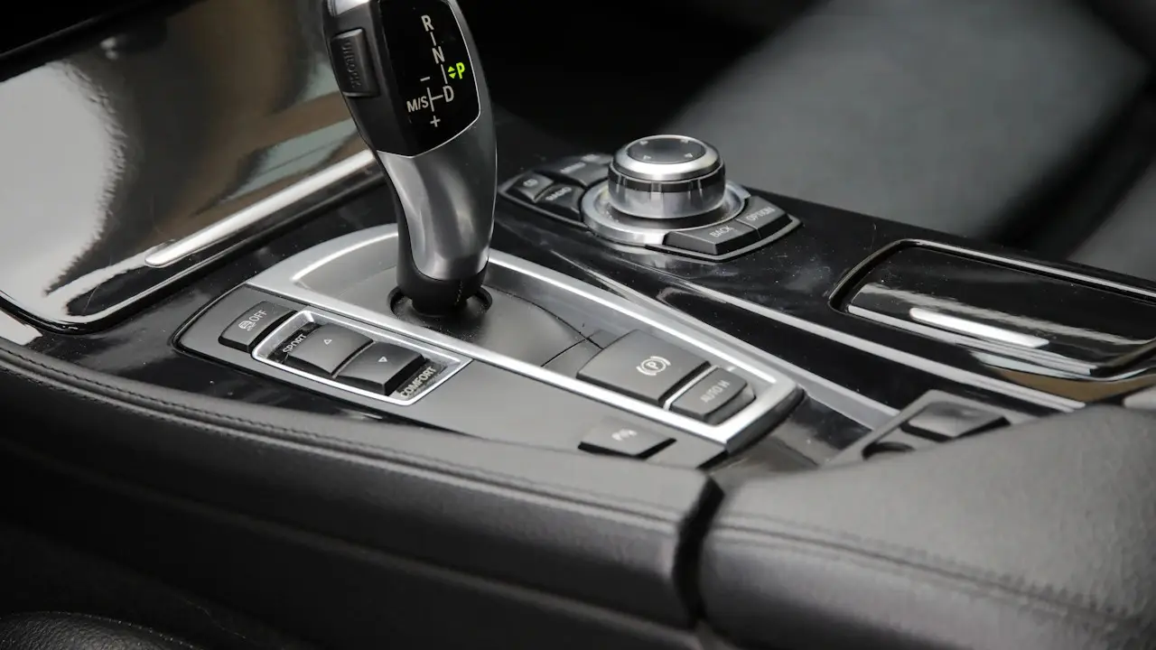 An automatic gear selector and drive-mode buttons in a car’s centre console.