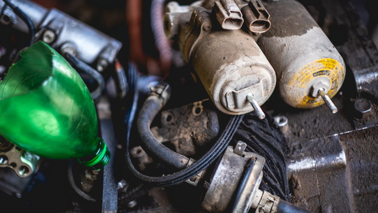An engine bay photographed close up with electrical components and wiring in view