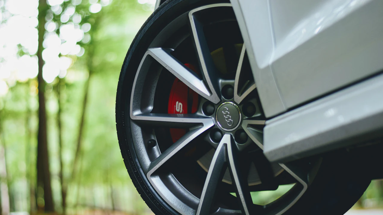 A red brake caliper visible behind an alloy wheel