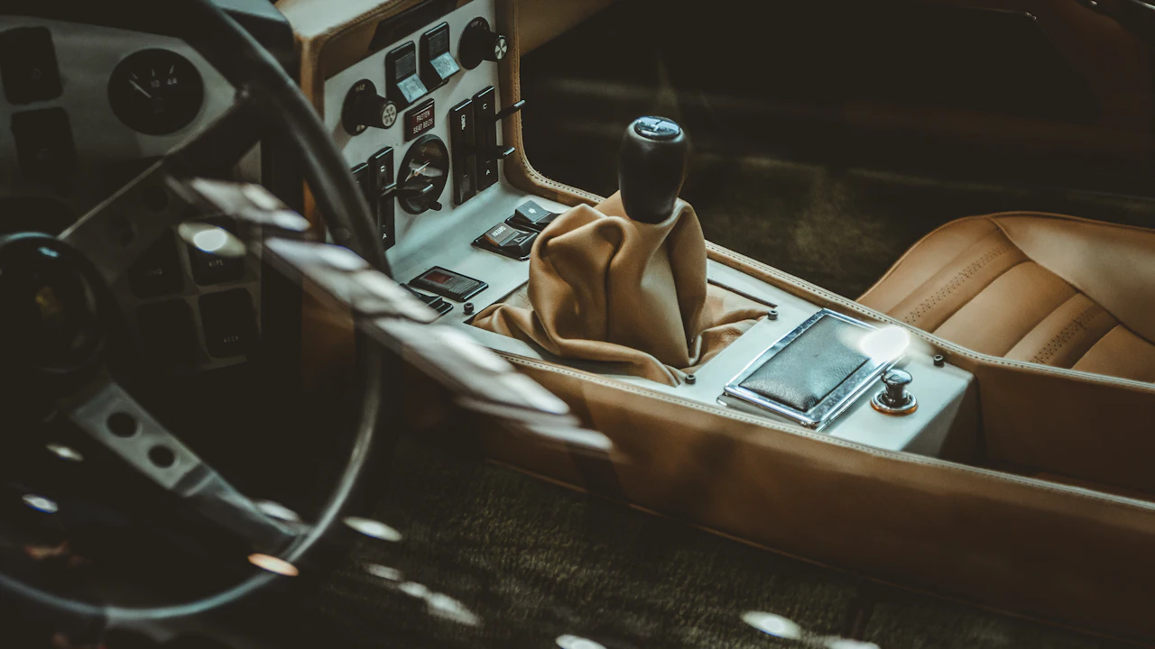 The gear shifter of a manual-transmission car, the driveline a clutch pedal operates