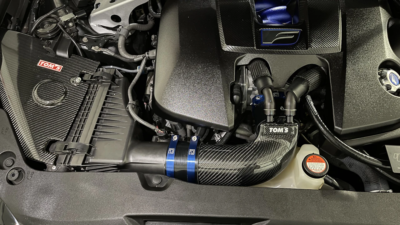 A car engine bay showing a black air-intake box and intake hose, where the mass air flow sensor sits