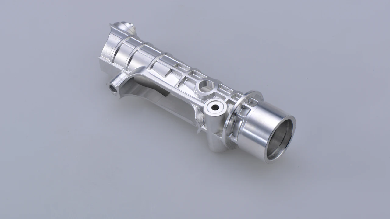 A machined aluminum automotive pump housing on a plain background