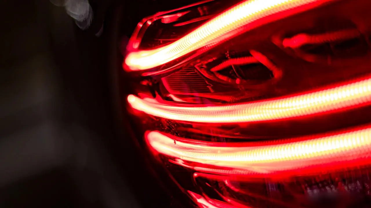 Close view of a car's lit red LED tail light.