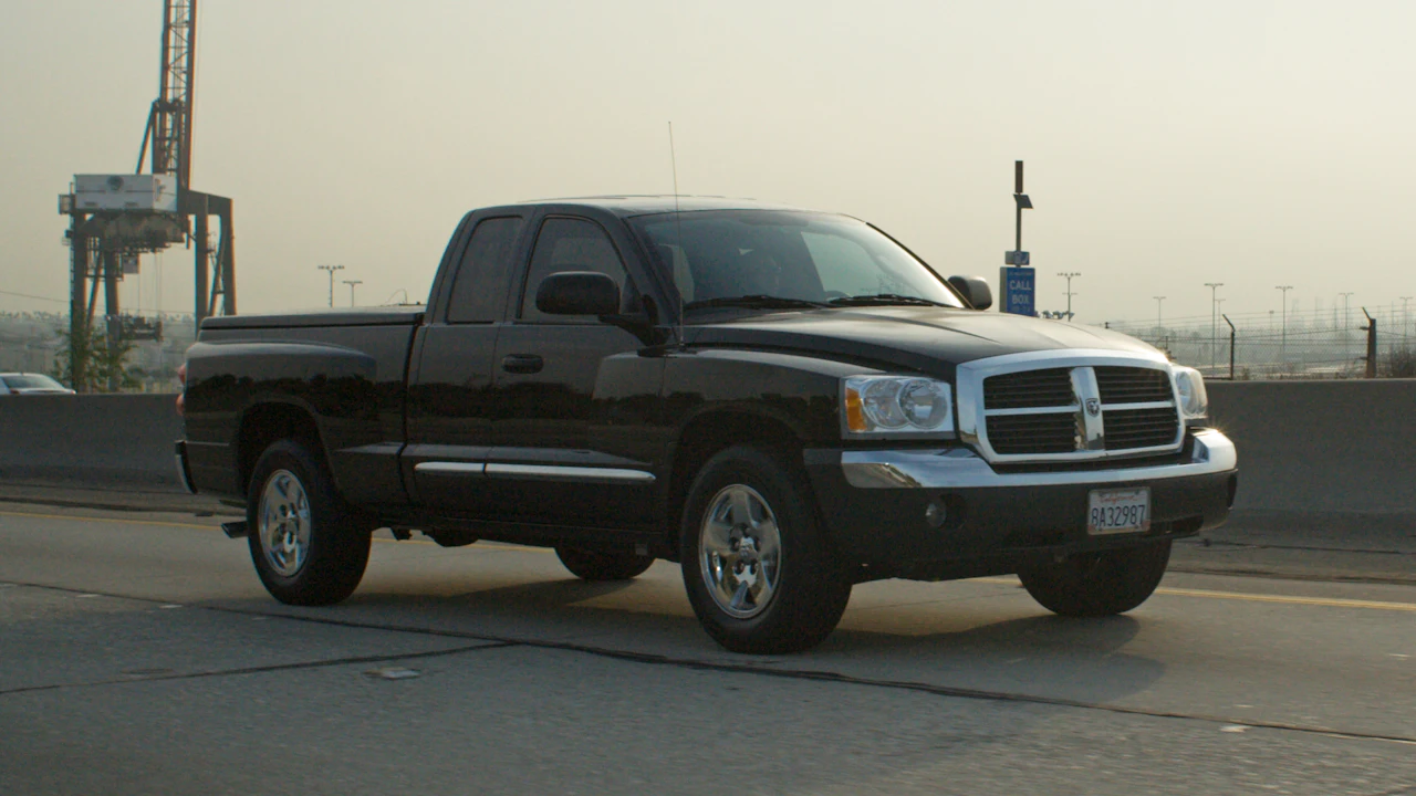 Black pickup truck driving on a highway