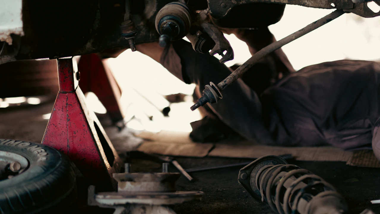 A car raised on jack stands with the underside and suspension exposed