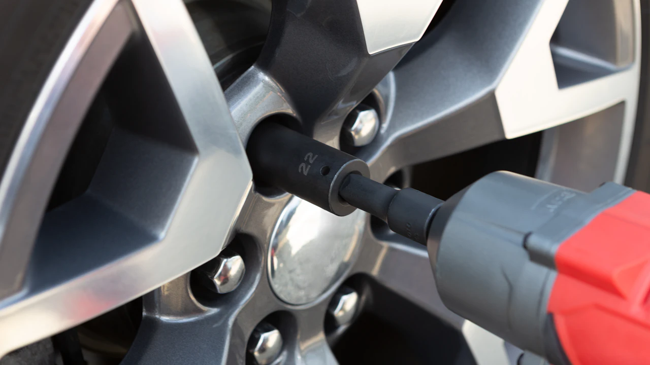 An impact wrench socket engaging a wheel nut on an alloy wheel